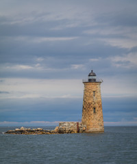 Fototapeta na wymiar Whaleback Lighthouse in Kittery, Maine, on a cloudy foggy day in early Fall, portrait