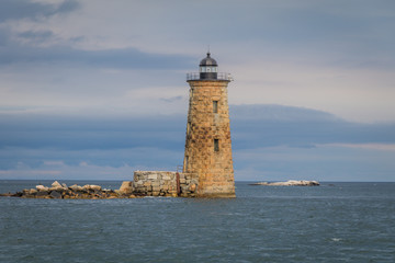 Fototapeta na wymiar Whaleback Lighthouse in Kittery, Maine, on a cloudy foggy day in early Fall