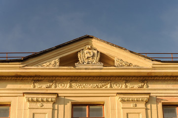 Soviet symbols on the gable of old building