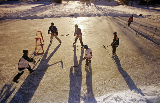 Boys playing hockey on outdoor rink, Winnipeg, Manitoba, Canada.