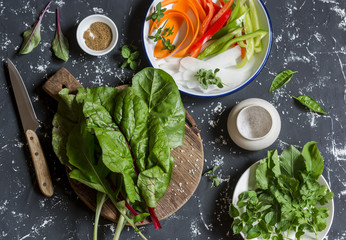 Ingredients to prepare vegetable rolls on dark background, top view. Vegetarian snack