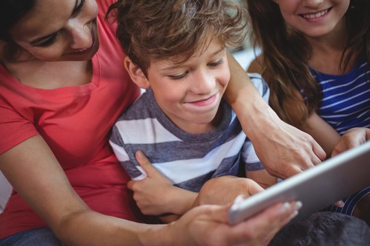 Mother And Kids Using Digital Tablet Together