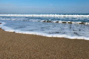Wave on the sand beach with foamy
