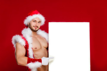 the very muscular  bronzed handsome sexy Santa Claus on red  bac