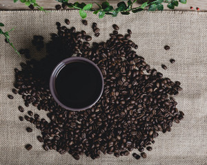 Cup of Black Coffee and Coffee Beans