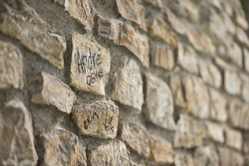 Side view of stone wall,with naughty alphabet , selective focus