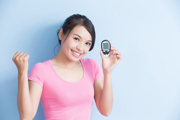 woman holding  blood glucose meter