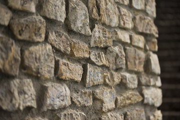 Side view of stone wall,with naughty alphabet , selective focus