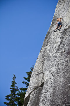 A strong male climber climbing Crescent Crack 10d, Squamish, BC