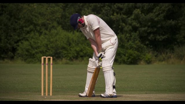 Batman strikes cricket ball cleanly.