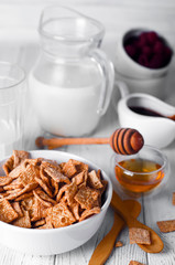 Breakfast cereal and a glass of fresh milk.
