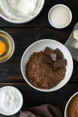 Food ingredients for cooking chocolate dessert on wooden backgro