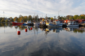 Small fishing boats in the harbor reflecting in the water