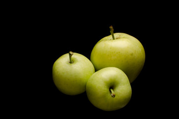 Green apples with black background