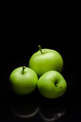 Green apples with black background
