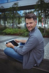 Fototapeta premium Portrait of handsome business executive using laptop