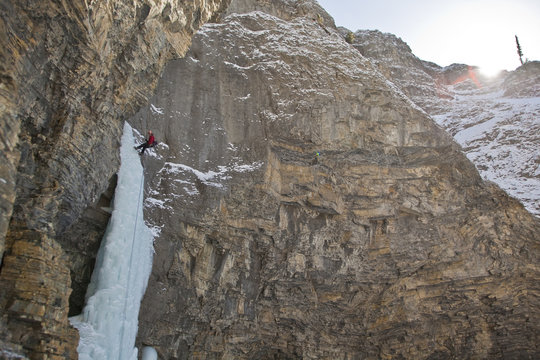 A man rappelling after free soloing the, Fang & Fist WI5, Ghost River Valley, Alberta, Canada