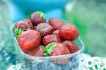 Fresh ripe strawberry in the plastic punnet