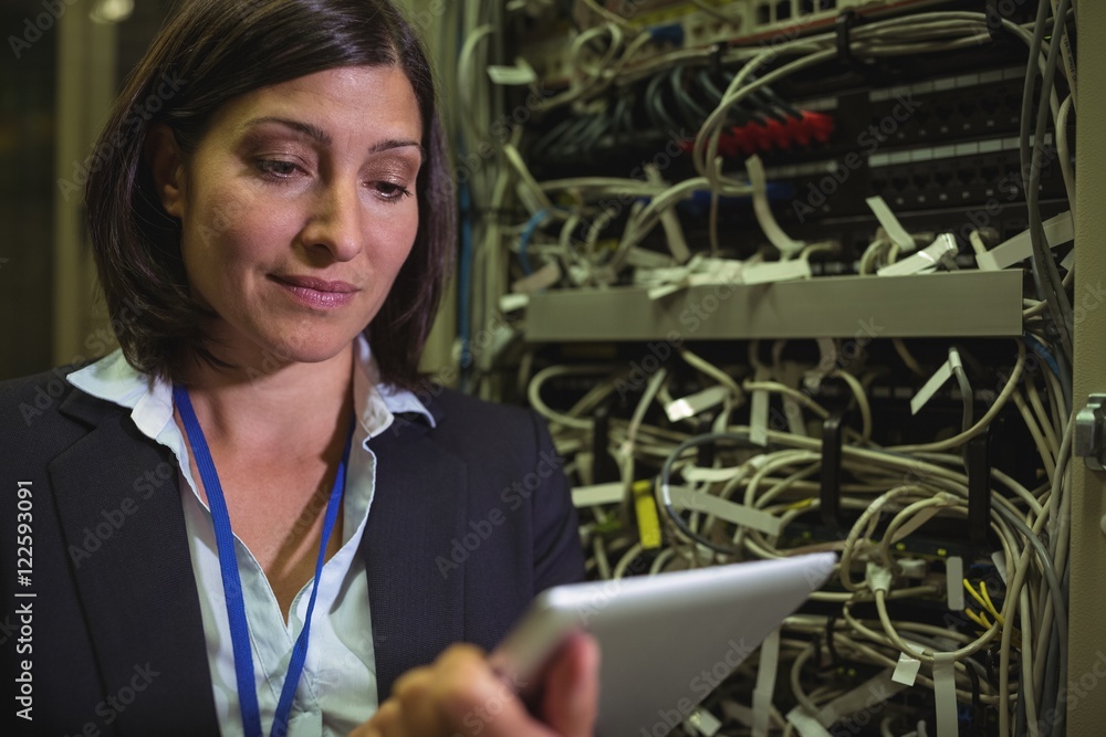 Aufkleber Technician using digital tablet while analyzing server