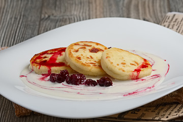 Pancakes with sower cream and cherry cyrup