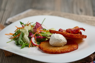 Classic potato pancakes with bacon and salad.