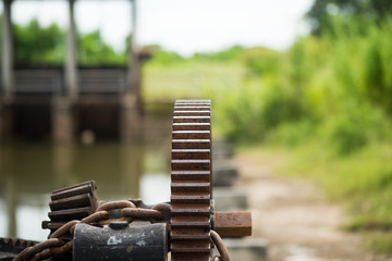 close up rusty and oily water gate gear.