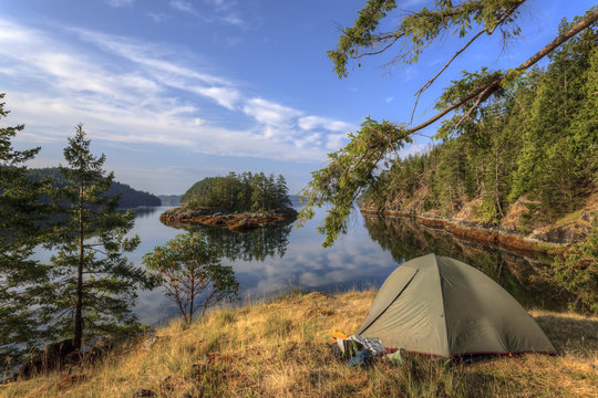 Kayakers camp on Penn Island in Sutil Channel between Read and Cortes Islands British Columbia Canada.