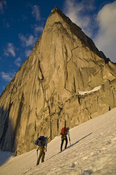 Two female climbers hike towards Bugaboo/Snowpatch Col in Bugaboo Provincial Park, BC.