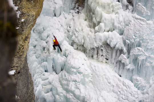 A male ice clmber tackles some steep ice in Johnstone  Canyon, Banff National Park, AB