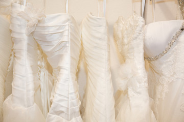 Few beautiful wedding dresses on a hanger