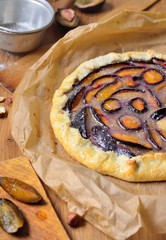 Sweet galette with plums and nuts hazelnuts
