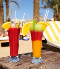 cocktails from fresh fruit in a tall glass with tubes