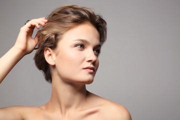 Portrait of beautiful young woman on color background