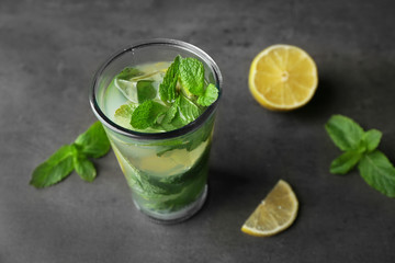 Delicious mojito with mint and lime slices on gray table