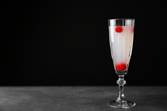 Delicious cocktail with berries on gray table