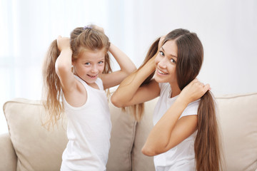 Fototapeta premium Cute girl with mother at home