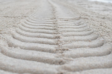 Fototapeta na wymiar Wheel track on sand ground