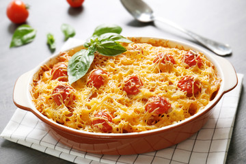 Delicious pasta Al Forno in ceramic bowl on napkin, closeup