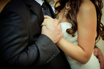 Close-up of newlyweds hands holding