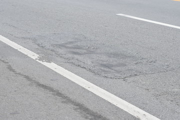 Old worn and cracked asphalt with cracks