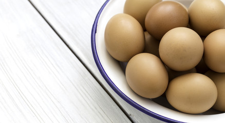 Bowl of country eggs on the wooden background