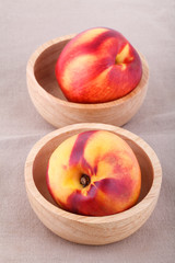 nectarines in bowl on wood table