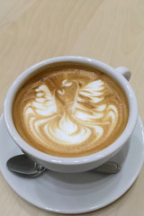 Close-up latte art coffee on wood background..