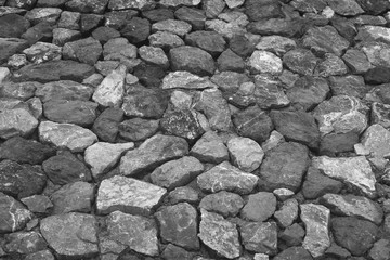 Stacked Stone Wall background and texture,black and white filtered image
