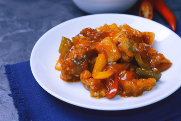 sweet and sour pork with rice. deep fried crispy pork stir fried with pineapple and fresh capsicum in sour and sweet sauce. worldwide famous chinese cuisine. 