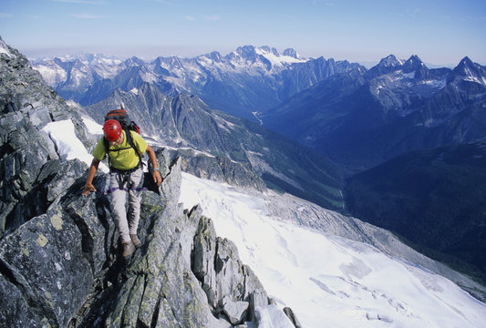 Rock climber, Anthony Comazzetto, climbing along the Asulkan Ridge traverse near the summit of Mount Jupiter, Rogers Pass, Glacier National Park, British Columbia, Canada