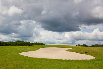 Sand golf bunker on a empty golf course before rain