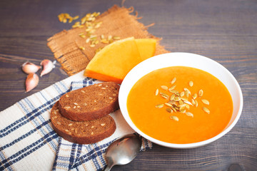 Pumpkin soup on a wooden table