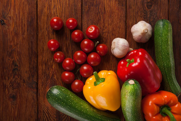 Fresh vegetables on brown wood background