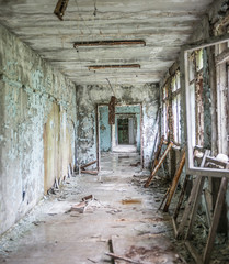 Obraz na płótnie Canvas gloomy corridor with broken window frames and debris